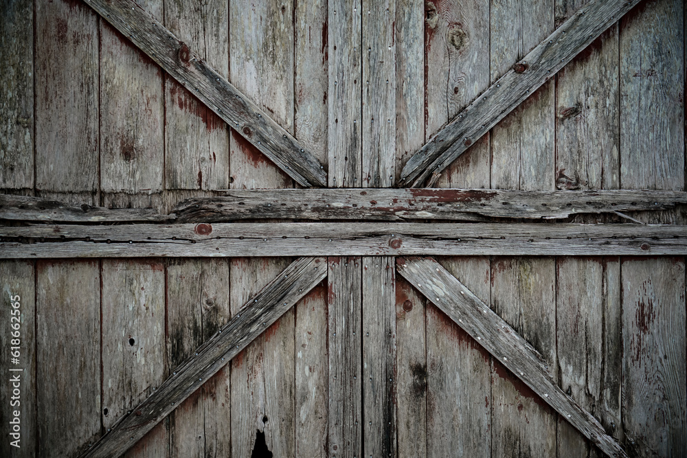 Dark stained reclaimed wood surface with aged boards lined up. Wooden