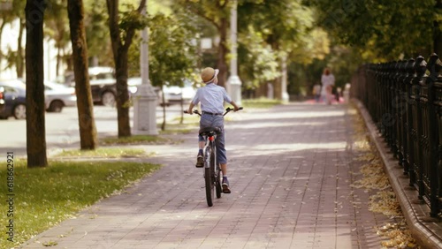 Wallpaper Mural Exploring the Outdoors: Thrilling Summer Bike Ride with a Happy Boy in a Picturesque Park Rear View Torontodigital.ca