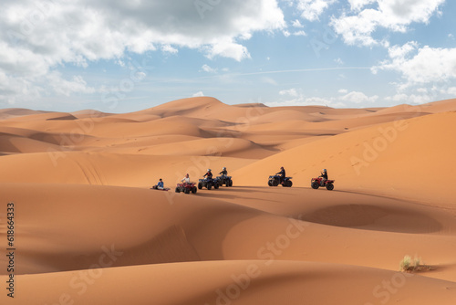 Motorbikers driving off-road in the Erg Chebbi desert near Merzouga in Morocco