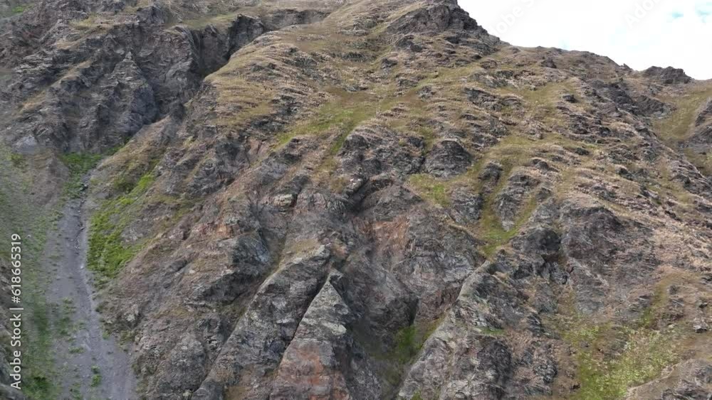 Aerial shot of Rocky Mountain Goats Climbing a steep mountaintop cliff in Svaneti mountains. Georgia Aerial shot of Rocky Mountain Goats Climbing a steep mountaintop cliff in Svaneti mountains. Georgia