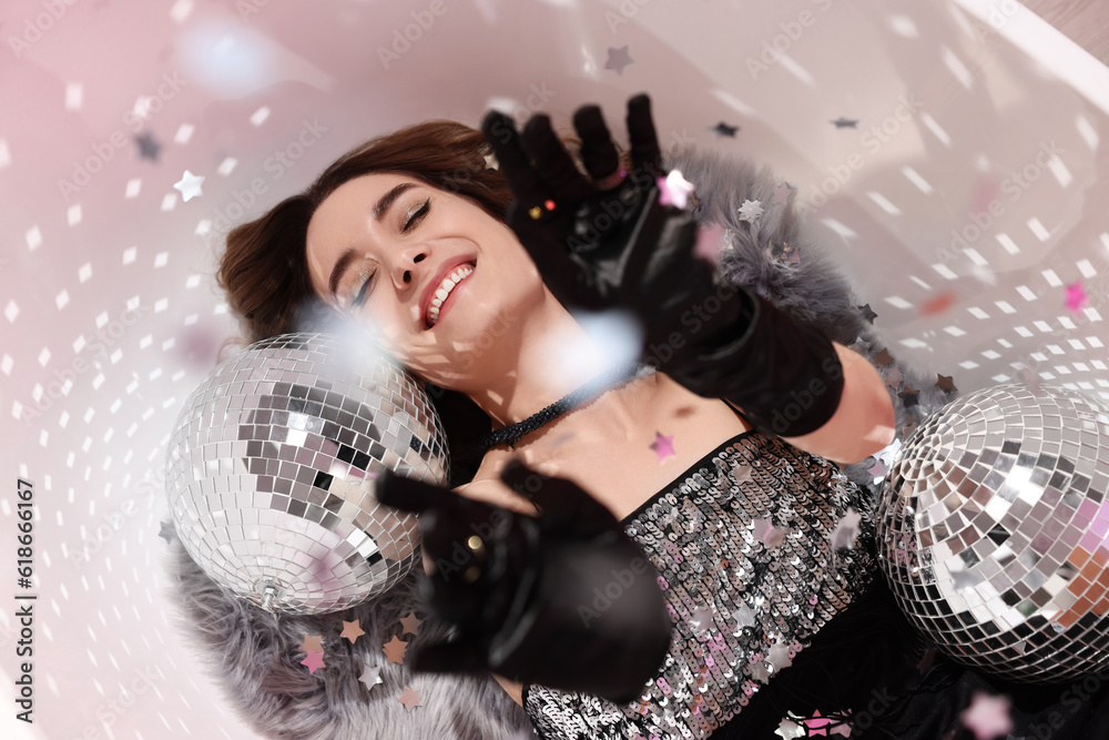 © New Africa - Beautiful woman in gorgeous dress among disco balls under falling confetti in bathtub, above view © New Africa - Beautiful woman in gorgeous dress among disco balls under falling confetti in bathtub, above view