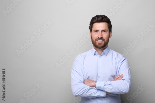 Portrait of handsome man on light grey background, space for text