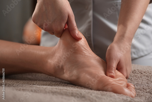 Woman receiving foot massage in spa salon, closeup © New Africa