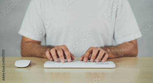 Crop picture of hand man typing white keyboard. Freelance business man search engine or using chat gpt technology AI for working video call conference or seacrh job or browse internet on laptop. photo