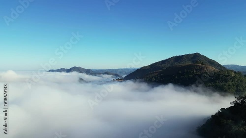 Unveiling Nature's Tranquil Majesty: Aerial Drone Footage of Breathtaking Fog-Clad Mountainscapes photo