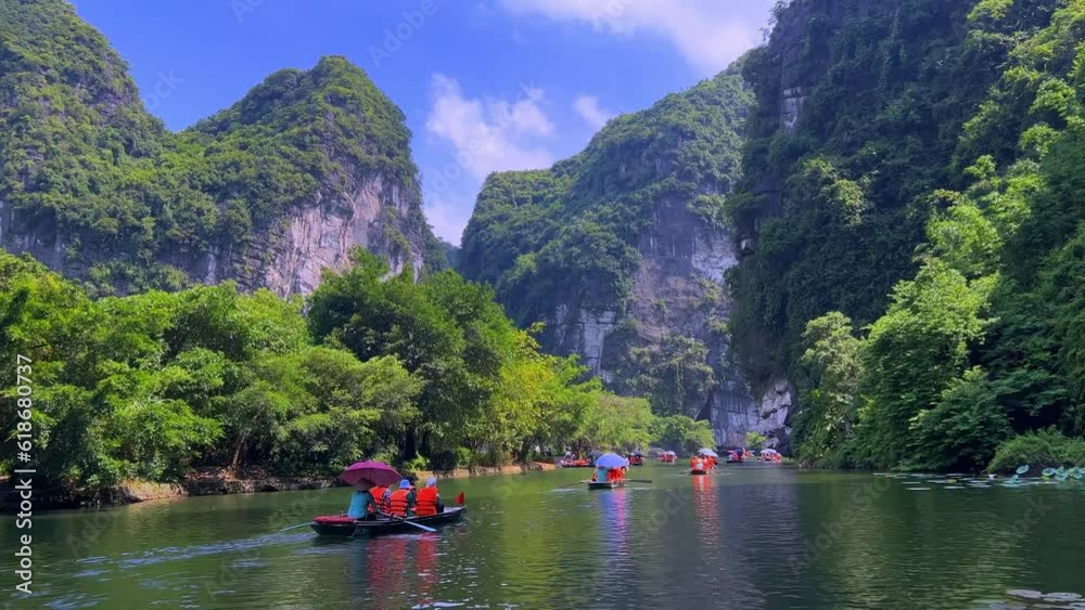 Trang An River Ninh Minh and Bai Dinh Mountain ranges in Vietnam only 3 hours drive from Hanoi. Beautiful winding river and large rising mountains. boats going through the caves in the river