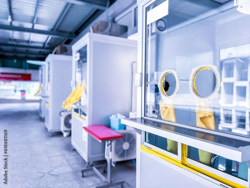 Medical equipment that is damaged from use. A cabinet with rubber gloves for COVID-19 testing in hospital at Thailand. Device for working healthcare worker inside permanent PCR testing station.