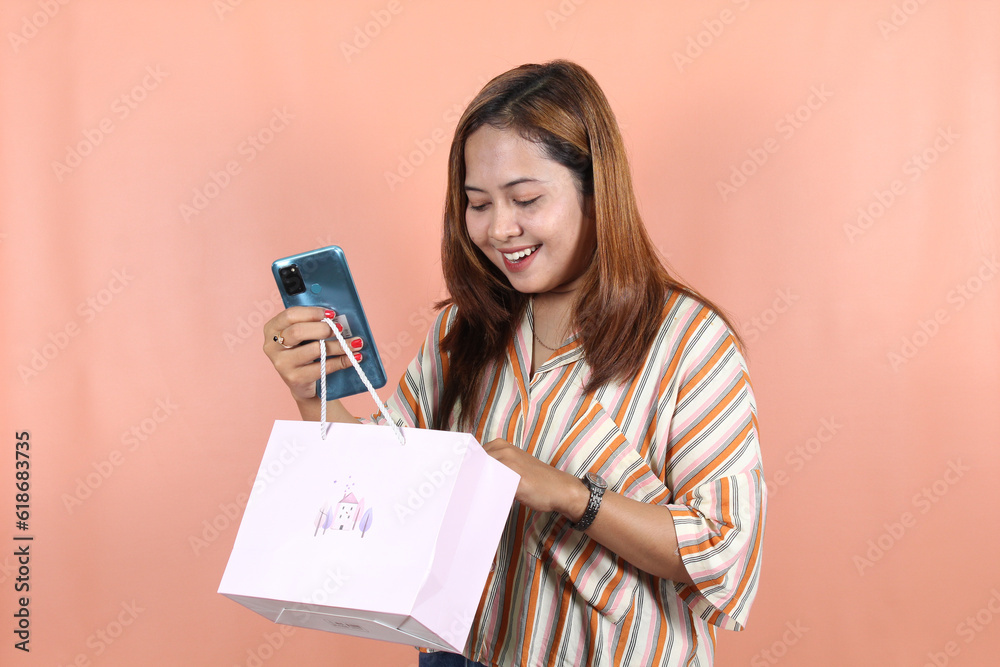 Asian happy female woman girl holds shopping package Asian happy female woman girl holds shopping package