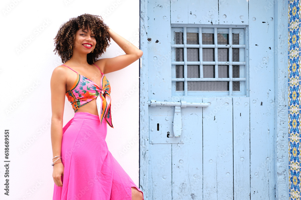 A Joyful Girl, Her Playful Hair, and the Alluring Blue Door A Joyful Girl, Her Playful Hair, and the Alluring Blue Door
