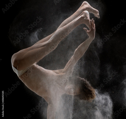 Man doing handstand in a white dust cloud view