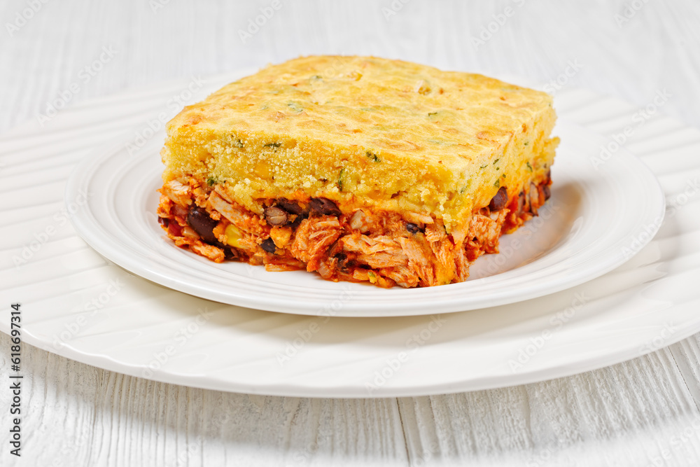 Chicken Tamale Pie on white plate, top view Chicken Tamale Pie on white plate, top view
