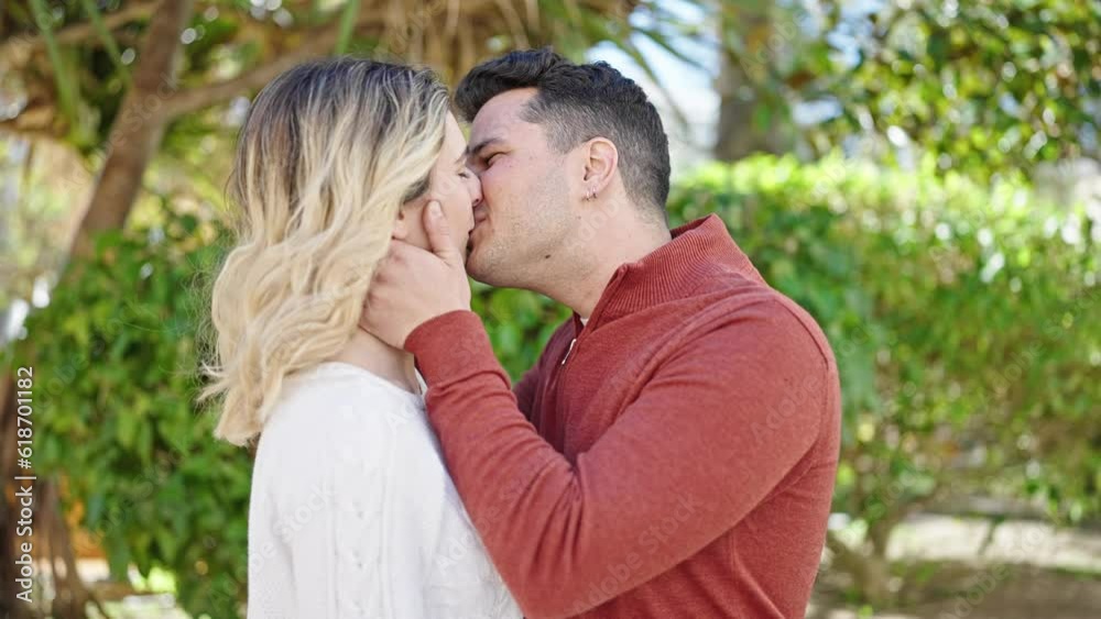 Man and woman couple kissing at park Man and woman couple kissing at park