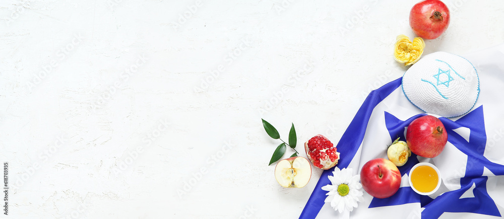 Flag of Israel, kippah, pomegranates, apple, flowers and honey on light background with space for text. Rosh Hashanah (Jewish New Year) celebration