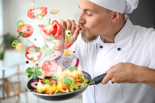 Male chef cooking tasty vegetables in kitchen