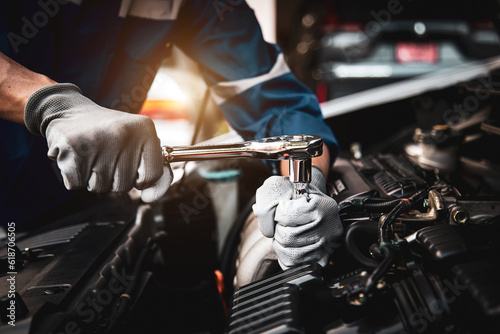 Car care maintenance and servicing, Hand technician auto mechanic using the wrench to fix car or repairing change spare part engine problem and insurance service support the range of car check.