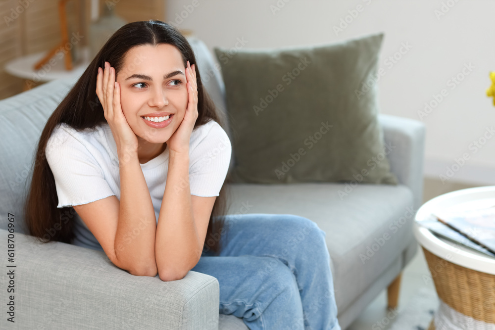 Dreaming young woman on sofa at home Dreaming young woman on sofa at home