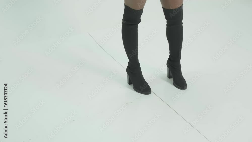 Young swarthy woman with long black hair in short shorts dancing on white background Young swarthy woman with long black hair in short shorts dancing on white background