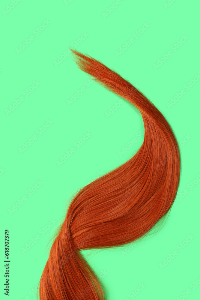 Beautiful ginger hair on color background