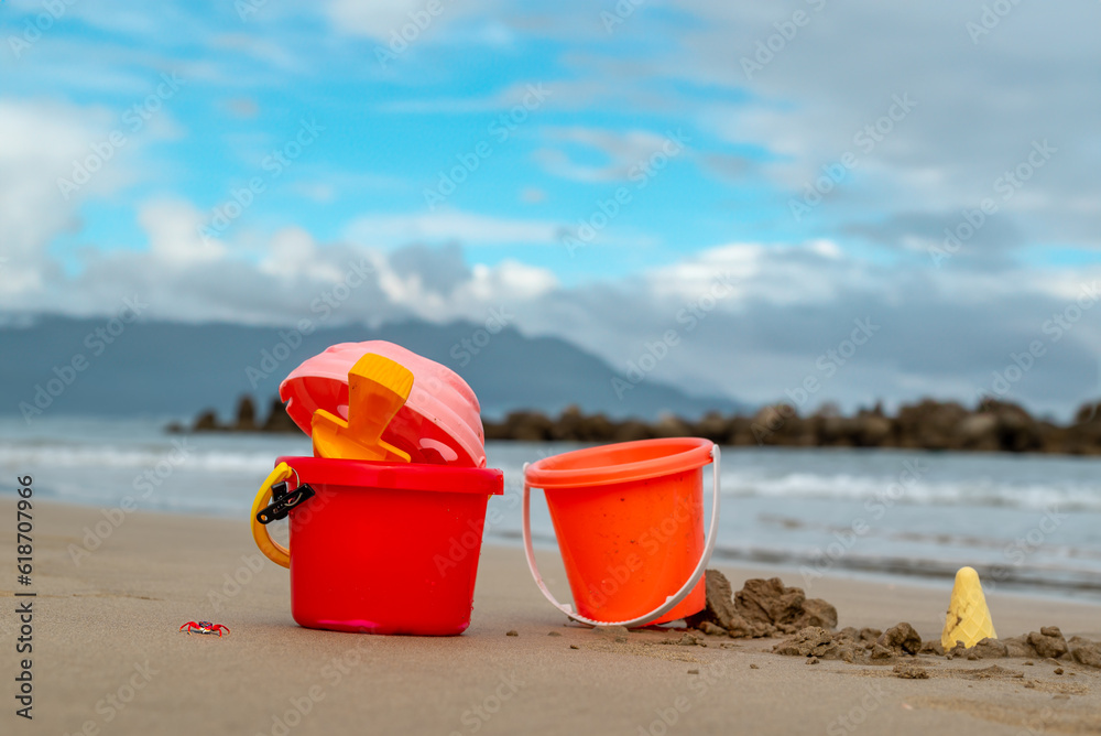 Pail bucket and kids toys on the beach sand Pail bucket and kids toys on the beach sand