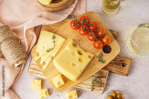 Konstfotografi Boards with pieces of Swiss cheese and tomatoes on white table