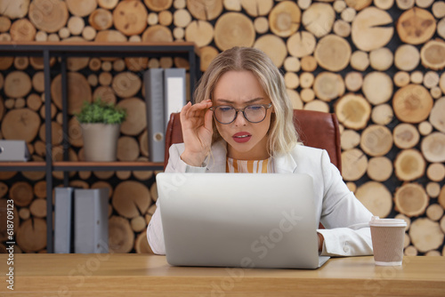 Young businesswoman working with laptop in office