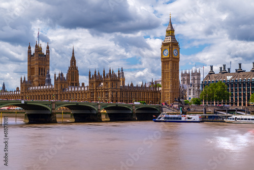 Amazing London cityscape what is included the Big Ben, Goverment's parliament. Westminster abbey's towers is on the background. Thames river and westminster bridge. With tipical english cloudy sky. photo