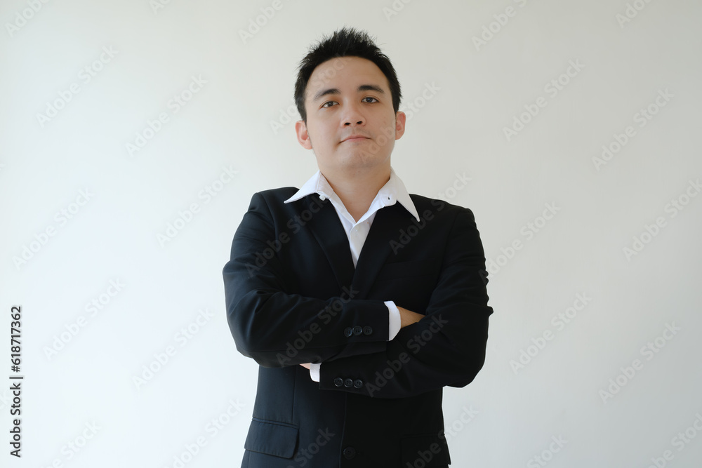 Young Asian businessman standing and looking in front of the camera. Isolated white background. Young Asian businessman standing and looking in front of the camera. Isolated white background.