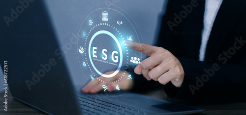 ESG. environment social governance investment business concept. Businessmen use a computer to analyze ESG, surrounded by ESG icons close to the computer screen in business investment strategy concept.