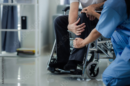 Male patient sitting in wheelchair undergoing a medical examination with specialist physician  treating injuries Getting medical treatment from specialist doctor can get the right and proper treatment