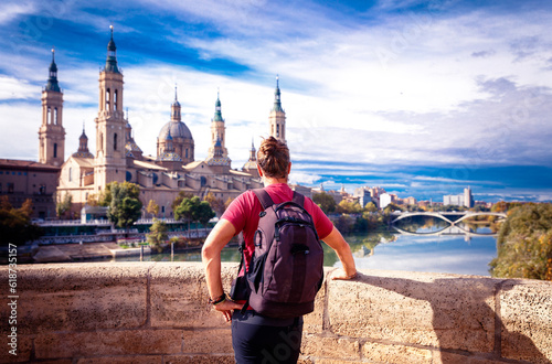 Zaragoza, panorama city landscape at sunset- Man tourist looking at view of cathedral at sunset