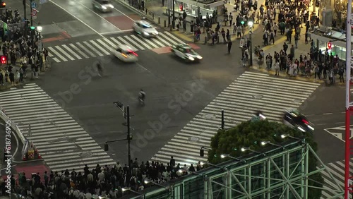 Wallpaper Mural SHIBUYA, TOKYO, JAPAN : Aerial time lapse view of Shibuya crossing at night. Crowd of people walking at the crossing in busy rush hour. Japanese people and urban city nightlife concept 4K video. Torontodigital.ca