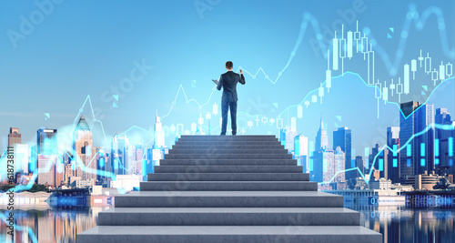Man on stairs drawing financial graphs in city sky