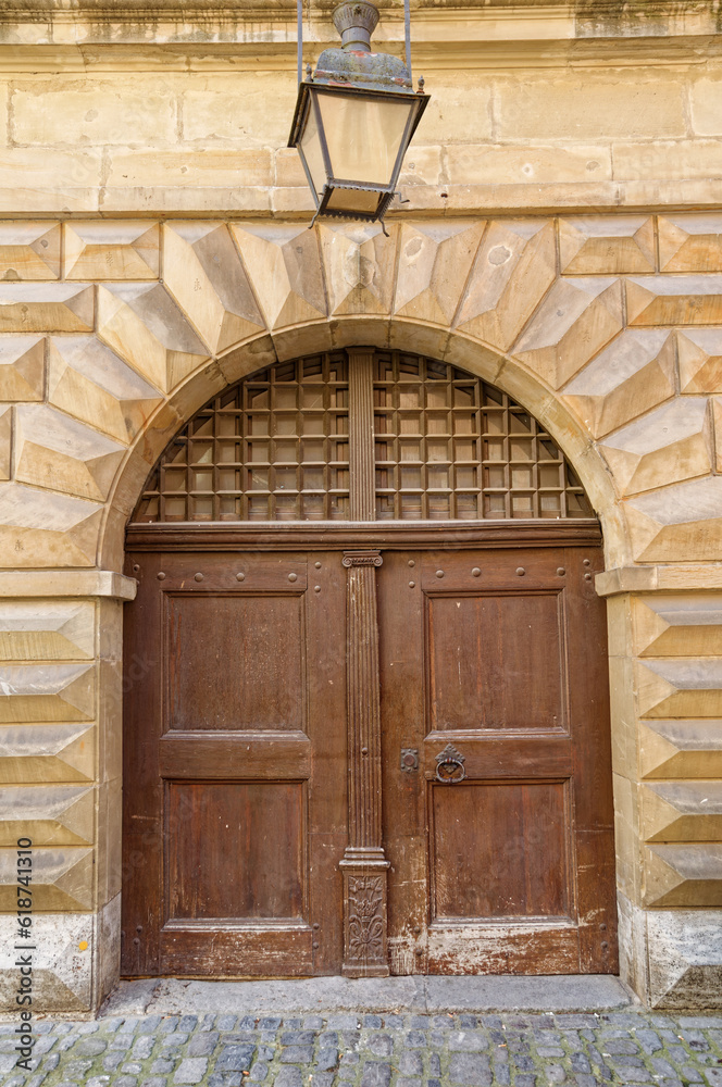 the entrance to a building with a brown door and arche