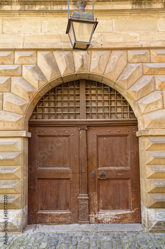 the entrance to a building with a brown door and arche
