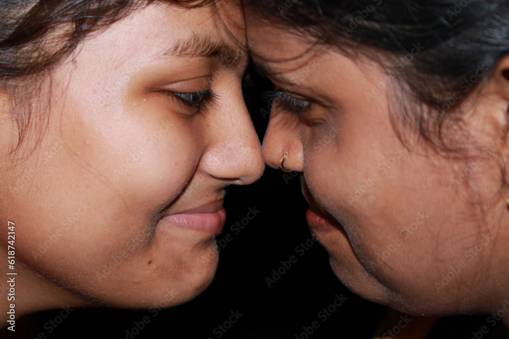 Two young beautiful Indian girl and woman on a black background. Two young beautiful Indian girl and woman on a black background.