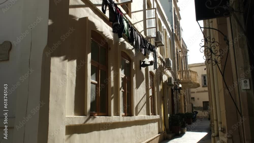 Video capturing the simple yet poignant image of laundry hanging from the window of a historic building in the winding streets of Icheri Sheher, Baku's old city. Video capturing the simple yet poignant image of laundry hanging from the window of a historic building in the winding streets of Icheri Sheher, Baku's old city.