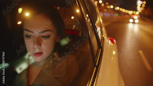Young smiling Businesswoman in the car is reading messages on her mobile
