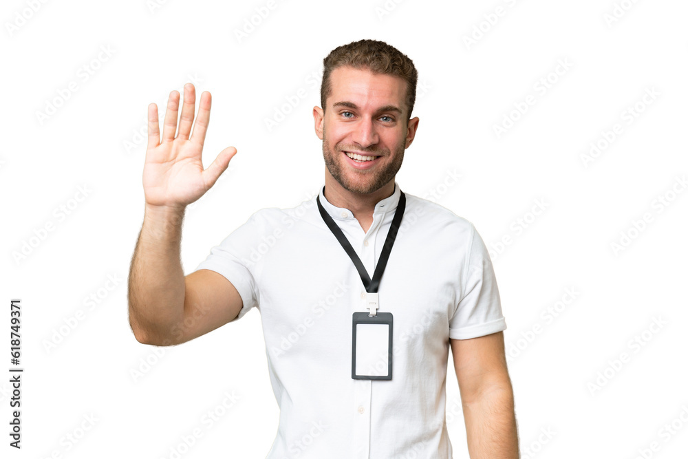 Young caucasian man with ID card isolated on green chroma background saluting with hand with happy expression Young caucasian man with ID card isolated on green chroma background saluting with hand with happy expression