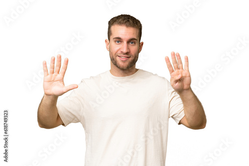 Young handsome caucasian man isolated on green chroma background counting nine with fingers © luismolinero