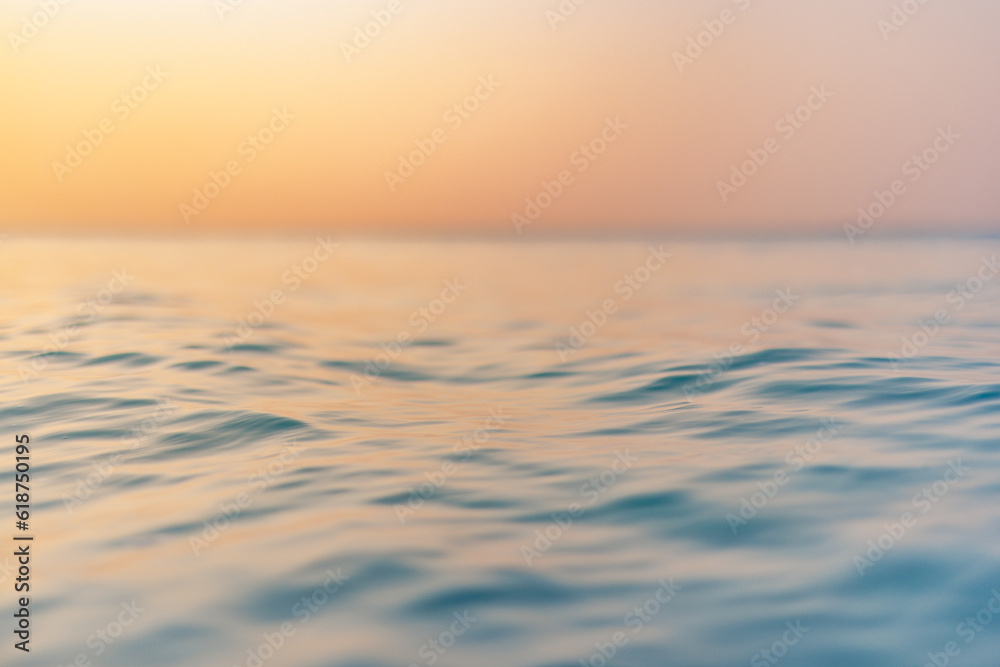 Sea wave closeup, low angle view, sunrise sunset sunlight. Idyllic Earth day seascape. Calm waves, golden orange sky horizon. Tranquil graphic illustration background. Minimal inspire ocean wallpaper