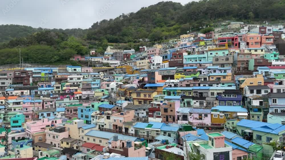 Beautiful view of small colorful buildings on the mountainside by a coastline