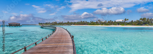 Maldives paradise panoramic coast. Tropical aerial seascape closeup wooden pier water villas, amazing sea happy sky. Exotic nature. Tranquil travel landscape peaceful bright summer vacation background © icemanphotos