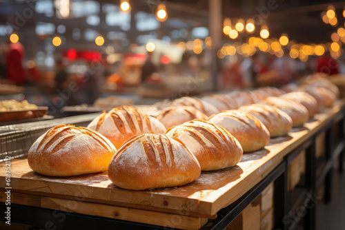 A photograph highlighting a market stand specializing in artisanal bread, with crusty baguettes, fluffy buns, and aromatic loaves, showcasing the craftsmanship of breadmaking in