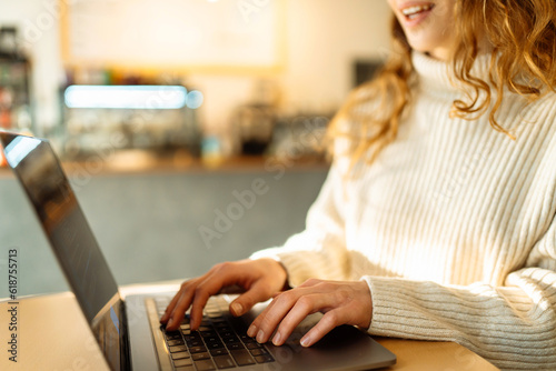 Female hands working on a laptop, close-up. Freelance, online course, remote work and lifestyle concept. Online shopping with laptop