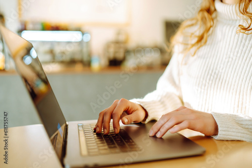Female hands working on a laptop, close-up. Freelance, online course, remote work and lifestyle concept. Online shopping with laptop