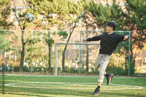 Asian Korean young male college athlete model controlling the ball with his feet and chest