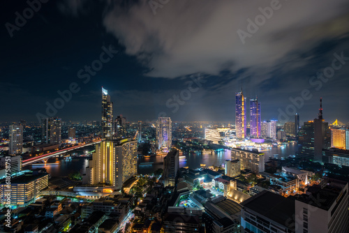 Aerial view of Bangkok skyline and skyscraper in Bangkok downtown. Panorama over Chao Phraya River Bangkok Thailand at sunset.