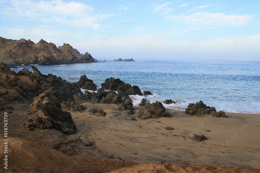 Scenic view of a beach featuring large rocks scattered along the shoreline. Peru.
