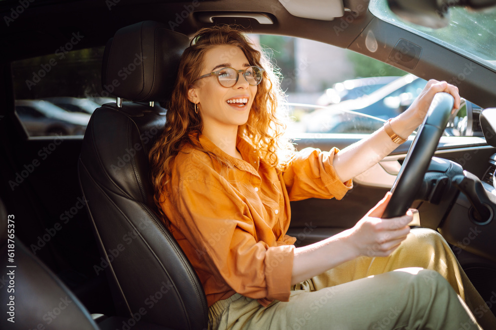 Smiling woman driving a car. Young traveler driving. Car travel, lifestyle concept. Smiling woman driving a car. Young traveler driving. Car travel, lifestyle concept.