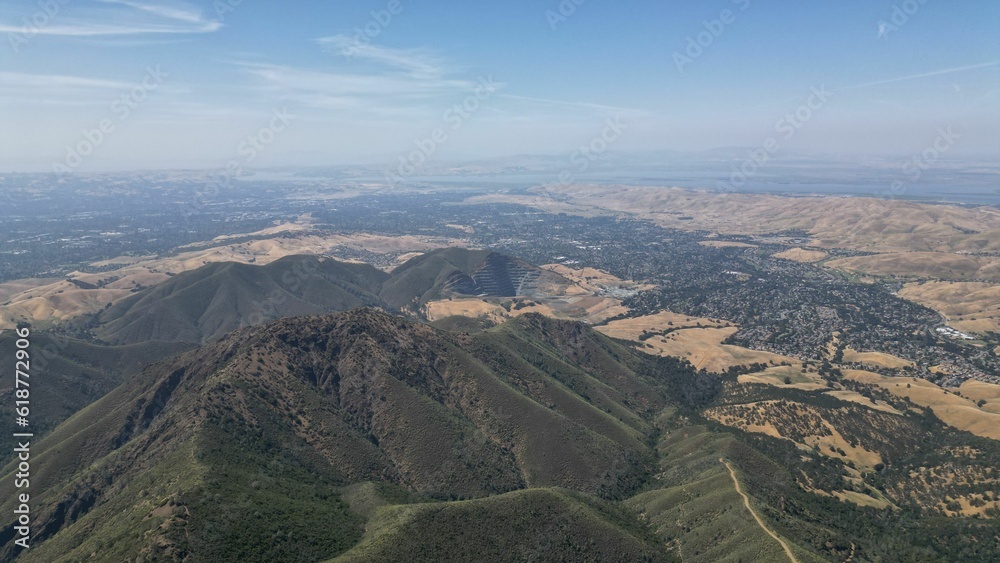 an aerial view of a landscape in the distance with hills and houses